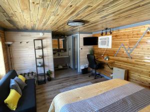 a bedroom with a bed and a desk in a room at The Whispering Elms Motel in Baker