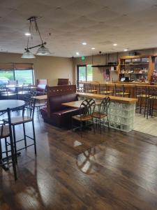 um restaurante com mesas e cadeiras e um bar em Quality Inn em Grayville
