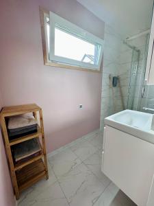 a bathroom with a sink and a tub and a window at Domek letniskowy Ińsko BIO BOX in Ińsko