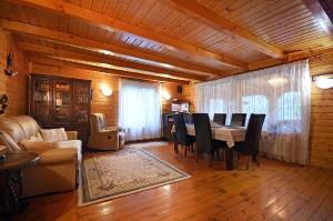 a dining room with a table and chairs in a room at Cabana Poiana Verde in Slănic-Moldova