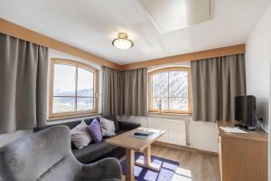 a living room with a couch and a table at Hotel Garni Birkhahn in Galtür