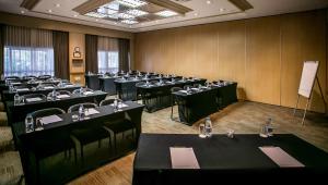 a room with rows of tables and chairs in it at Garden Court OR Tambo International Airport in Kempton Park