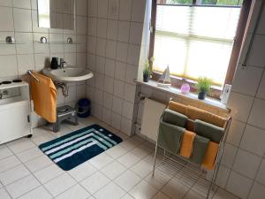 bagno con lavandino, specchio e portasciugamani di Fewo mit Burgruinenblick a Runding