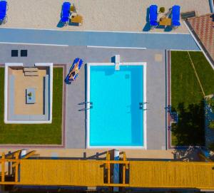 an overhead view of a large swimming pool at Koumaros Aparthotel in Agia Paraskevi