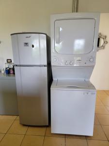 a refrigerator and a microwave in a kitchen at Villa Teresita - vista hermosa in Coco