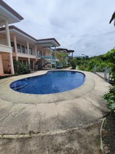 a pool in front of a house at Villa Teresita - vista hermosa in Coco