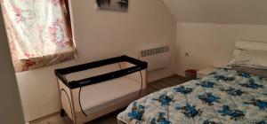 a small bedroom with a bed and a window at villa rayan in Hadžići