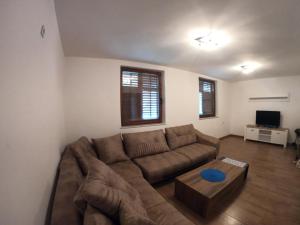 a living room with a couch and a coffee table at villa rayan in Hadžići