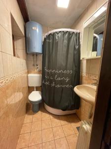 a bathroom with a shower curtain that says vengeance is a love not shower at Skikoliba 1 in Jahorina