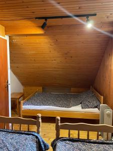 a bedroom with a bed in a wooden cabin at Skikoliba 1 in Jahorina