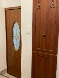 a wooden door with a stained glass window next to at Apartment Bessi in Olomouc