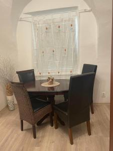 a dining room table and chairs in a room at Apartment Bessi in Olomouc