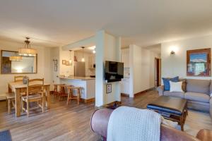 a living room and kitchen with a couch and a table at Walk to Ski Shuttle: Cozy Mountain Meadows Condo in Frisco