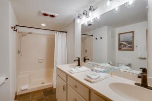 a bathroom with a sink and a large mirror at Walk to Ski Shuttle: Cozy Mountain Meadows Condo in Frisco +19 photos