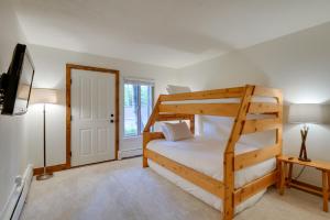 a bedroom with a bunk bed and a tv at Walk to Ski Shuttle: Cozy Mountain Meadows Condo in Frisco