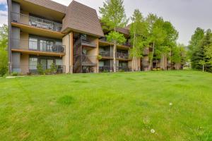 a large yard in front of a building at Walk to Ski Shuttle: Cozy Mountain Meadows Condo in Frisco