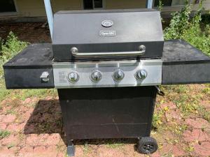 a grill sitting on the ground in a yard at MileHi Vacation Home in Aurora