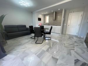 贝纳尔马德纳Luxury apartment Benalmadena First line的带桌椅和沙发的客厅