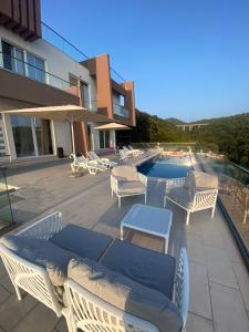 a patio with lounge chairs and a swimming pool at Villa La Reina in Bar