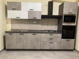 a kitchen with stainless steel cabinets and a stove at Casa Al Lago B&B in Foiano di Val Fortore