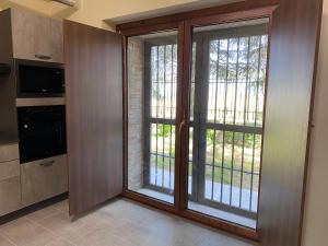 a kitchen with sliding glass doors in a room at Casa Al Lago B&B in Foiano di Val Fortore +12 photos