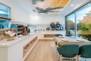 a kitchen and dining room with a table and chairs at Grand Horizon Luxury Boutique Apartments in Puerto Rico de Gran Canaria