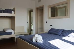 a bedroom with a bed with towels on it at Snorky apartments in Azzano San Paolo