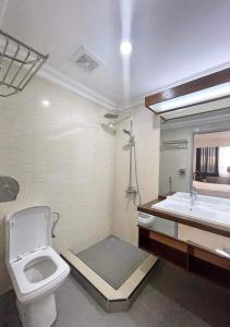 a bathroom with a toilet and a sink at RESIDENCE D ANKADIFOTSY in Antananarivo