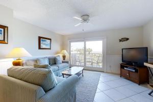 a living room with a couch and a tv at 207 Sailmaker in Fernandina Beach