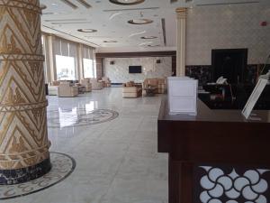 a lobby with couches and a column in a building at Quiet Rooms 7 Serviced Apartments in Riyadh