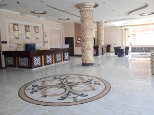 a lobby with a tile floor with a pillar at Quiet Rooms 7 Serviced Apartments in Riyadh