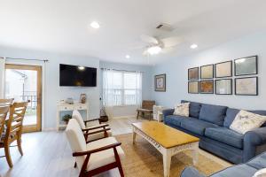 a living room with a blue couch and a table at 212 Sailmaker in Fernandina Beach