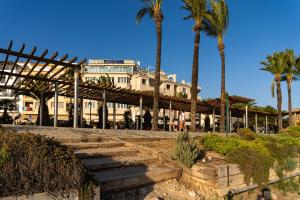 a building with palm trees in front of it at La Sort Boutique Hotel in Moraira