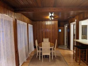 a dining room with a table and chairs at Mid Century Style Cottage Near Historic Downtown in Eustis