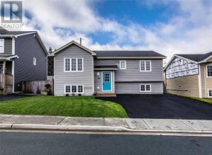 a gray house with a driveway in front of it at Lovely 2 Bedroom apartment close to Avalon Mall in St. John's