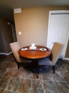 a wooden table and two chairs in a room at Lovely 2 Bedroom apartment close to Avalon Mall in St. John's