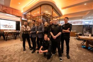 a group of people posing for a picture in a restaurant at Ratshotel in Haltern