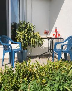 a patio with two chairs and a table with drinks on it at Bar Aperol Apartment in Bar