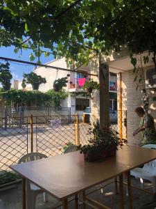 a wooden table and chairs in front of a building at Casa Petre in Eforie Nord