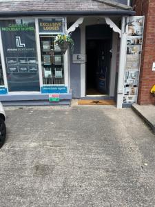 a store front with the entrance to a store at Holywell Apartment - Luxury One Bedroom Apartment in Holywell