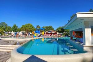 a swimming pool with a water park with a playground at Polidor Glamping Resort in Poreč