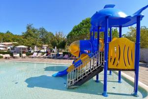 a blue and yellow playground in a swimming pool at Polidor Glamping Resort in Poreč