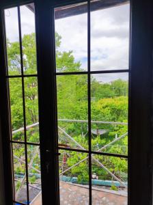 an open window looking out onto a garden at Our Village in Ashtarak
