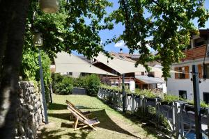 a park with a bench and a building at Casa Orso Elio - Si Mezzana Home in Mezzana +106 photos