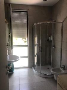 a bathroom with a shower and a sink at Illyrian Elite Gjiri i Lalezit in Durrës