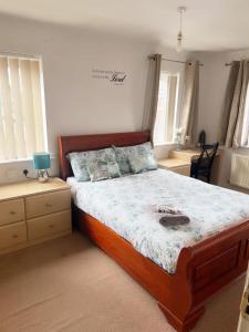 a bedroom with a large bed with a wooden frame at Harvard Road in Manchester