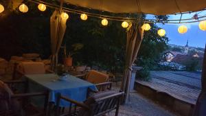 a table and chairs under a tent with lights at Ferienwohnung Sonnenschein Familie Hamdorf in Bad Sulza