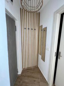 a hallway with a room with a door and a chandelier at Lara Residence in Băile Herculane