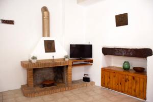 sala de estar con chimenea y TV en Anastasia Country Home en Strovlés