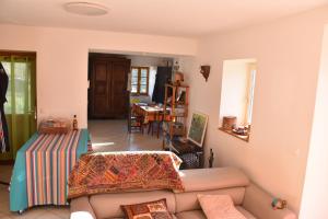 a living room with a couch and a table at Ancienne ferme tranquille en Haute Ardèche in Étables